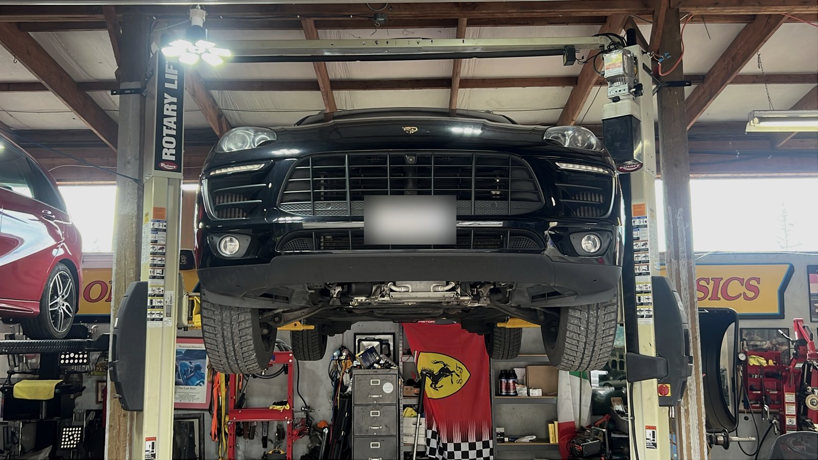 Porsche Cayenne raised on a lift in the Stop-Stop workshop