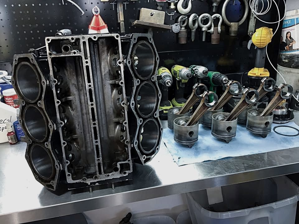 Outboard engine block and pistons on the workbench